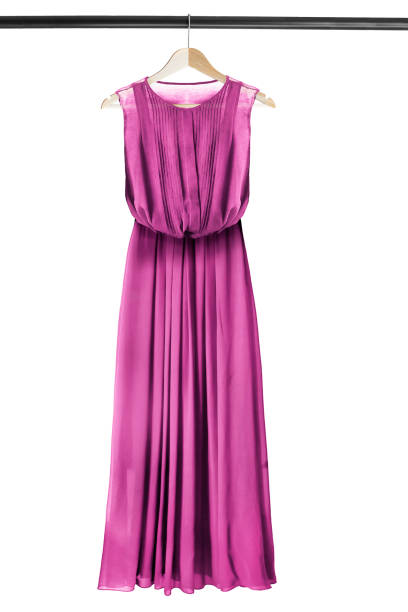Dress on clothes rack Magenta pink chiffon long dress on wooden clothes rack isolated over white pink gown stock pictures, royalty-free photos & images