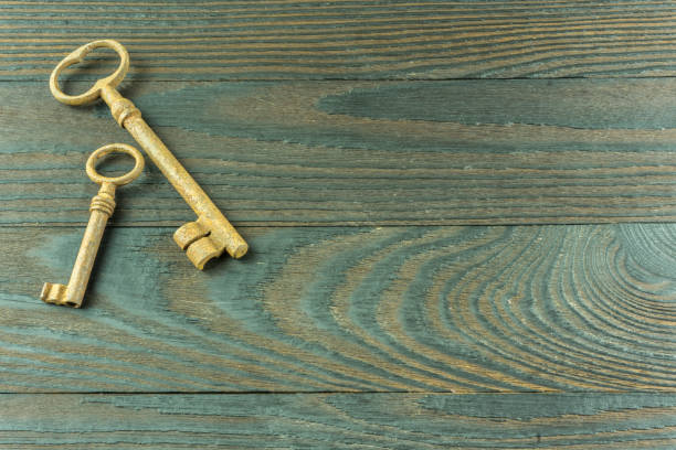 istock A rustic wooden board with two old keys as a background 700896286
