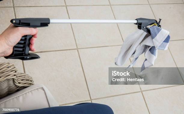 Patient Or Disabled Person Using A Grabber Reacher Stock Photo - Download Image Now