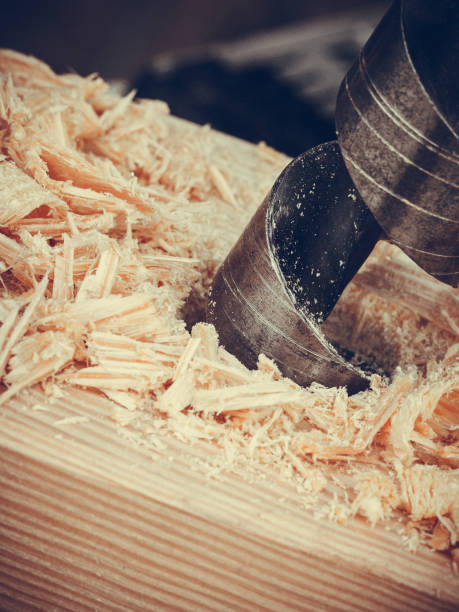 istock Metal machine drilling in wooden board 700901146