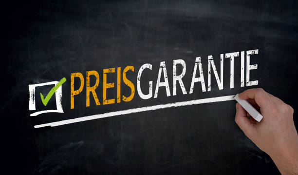 istock Preisgarantie (in german price guarantee) is written by hand on blackboard 700901818