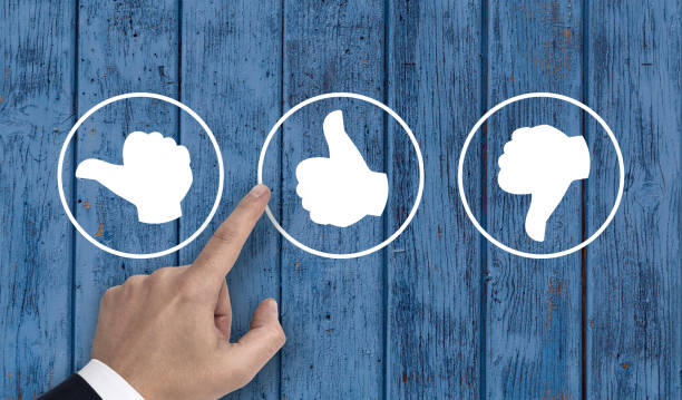 istock Hand pointing at rating icons with thumb 700910526