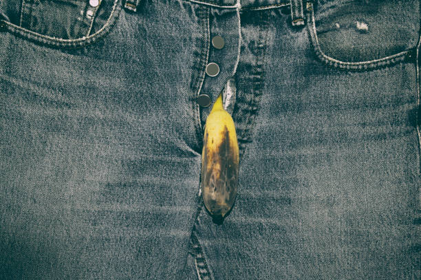 Symbolizing sexual dysfunction. Banana out of mens jeans. Symbolizing sexual dysfunction. Banana out of mens jeans. Impotency concept. aids walk stock pictures, royalty-free photos & images