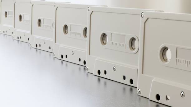 istock Endless line of white cassette tapes on a modern surface 700918634