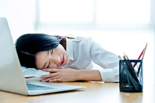 istock Businesswoman napping on desk 700923210