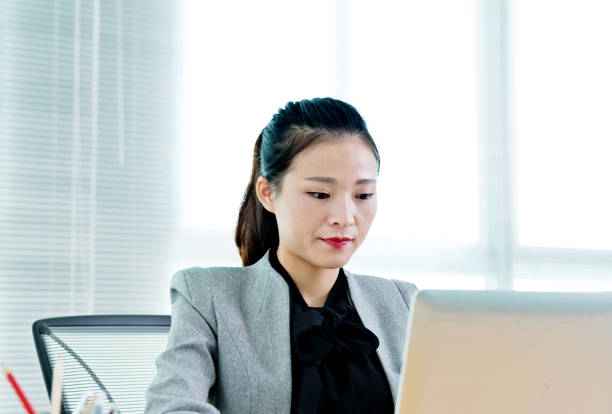 istock Beautiful businesswoman using laptop 700925264