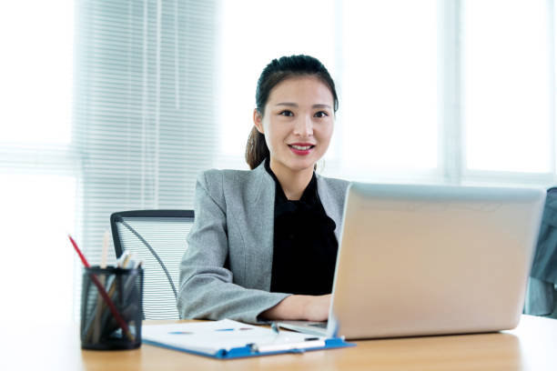 istock Beautiful businesswoman using laptop 700926354