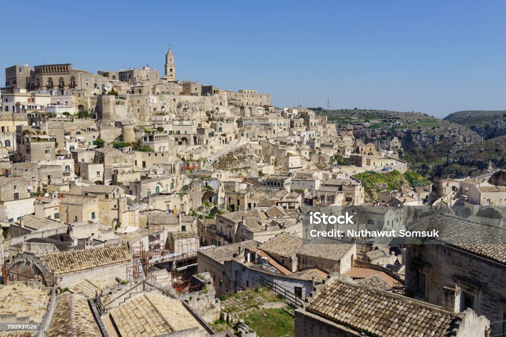 amazing panorama view of ancient ghost town of Matera (Sassi di Matera) in bright sun shine summer with blue sky, south Italy amazing panorama view of ancient ghost town of Matera (Sassi di Matera) in bright sun shine summer with blue sky, south Italy. Ancient Stock Photo
