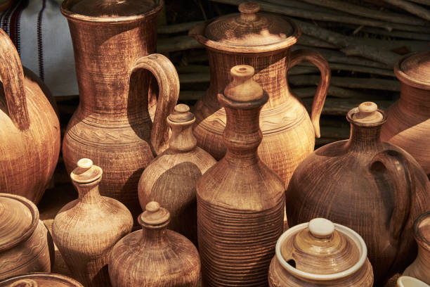 istock Monochrome ceramic handmade bottles and jugs under natural sunlight 700959596