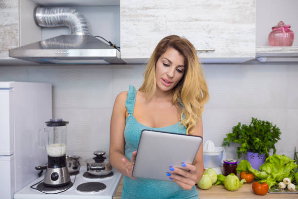 istock Attractive young woman in kitchen 700971932