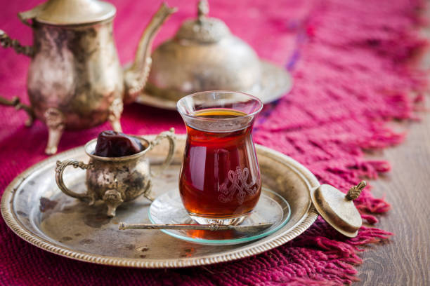 istock Tea set in oriental style in pear shaped glass with vintage kettle and dates fruit 700972586