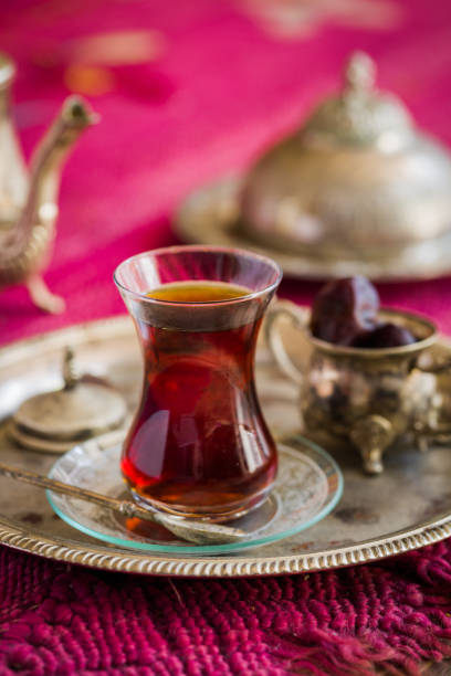 istock Tea set in oriental style in pear shaped glass with vintage kettle and dates fruit 700977312