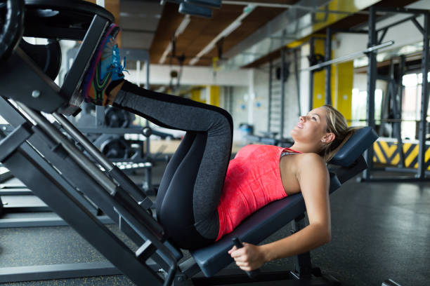 istock Woman doing exercises in gym for legs 700977330