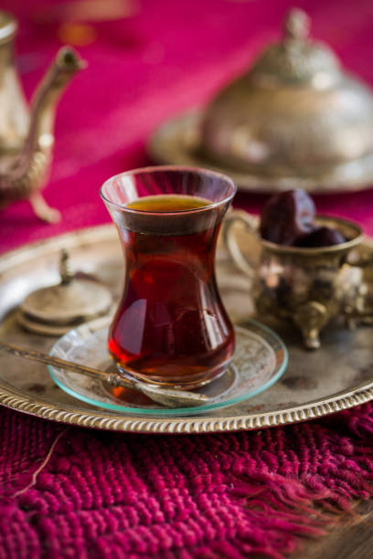 istock Tea set in oriental style in pear shaped glass with vintage kettle and dates fruit 700977336