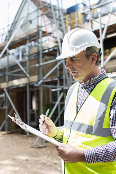 istock Building Inspector Looking At House Renovation Project 700994600