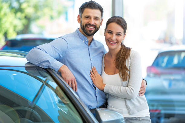 istock Young couple buying a car 700999114