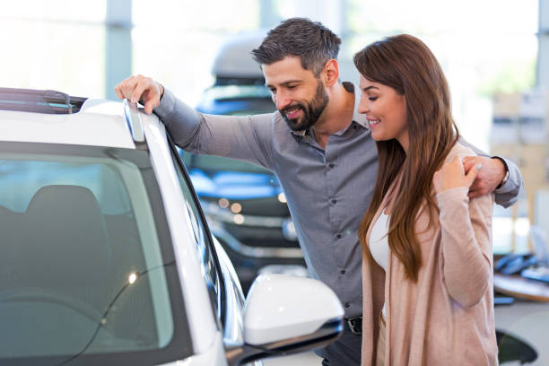 istock Young couple buying a car 700999248