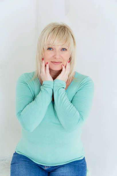 istock Blond woman with blue eyes in green 700999802