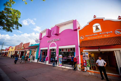 Cozumel, Mexico - December 29, 2016: Colorful shopping street in Cozumel with tourists shopping and sightseeing