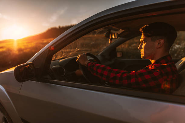 istock Portrait of young man in car 701007184