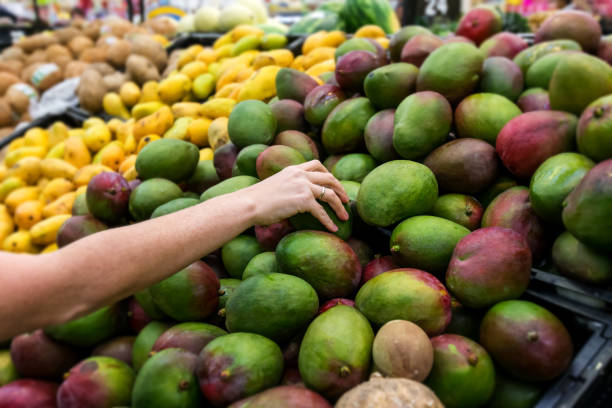istock Woman taking fresh mango at the market 701016818