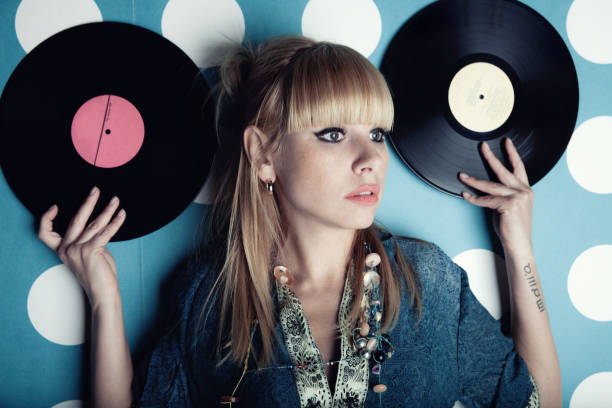 istock Young beautiful woman with vinyl records 701017330