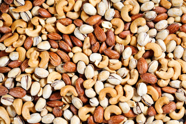 istock mix almonds, cashew nuts, peanuts, pistachio top view 701022106