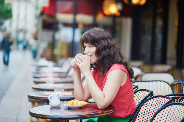 istock Woman drinking coffee in cafe 701029618