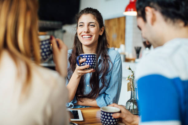 istock Woman having coffee while talking with friends 701029814