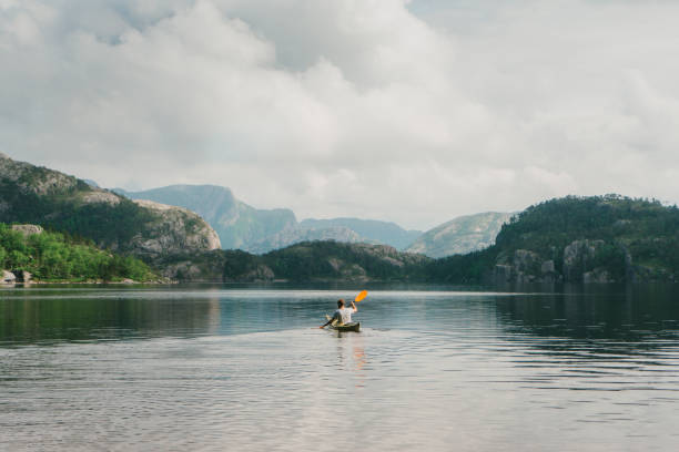 istock Man kayaking on the lake in Norway 701044610