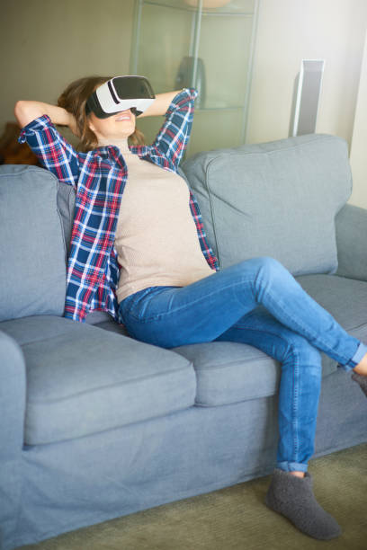 istock Young beautiful woman weating virtual reality glasses 701045354