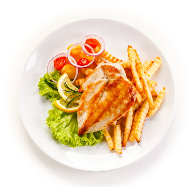 istock Grilled chicken breast with potatoes and vegetables salad 701045560