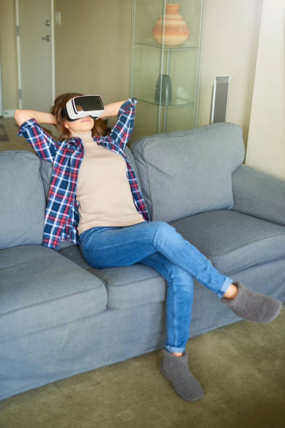 istock Young beautiful woman weating virtual reality glasses 701045640