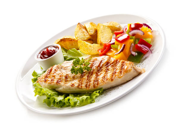 istock Grilled chicken breast with potatoes and vegetables salad 701049906