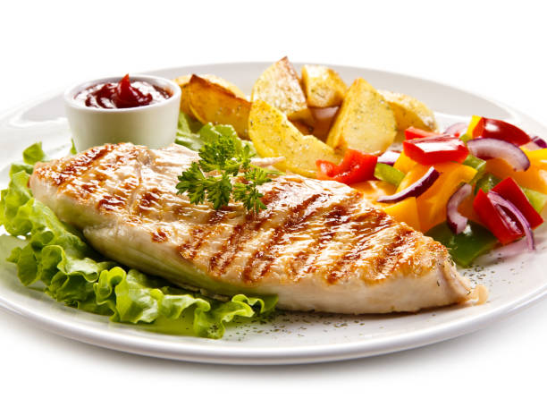 istock Grilled chicken breast with potatoes and vegetables salad 701049928