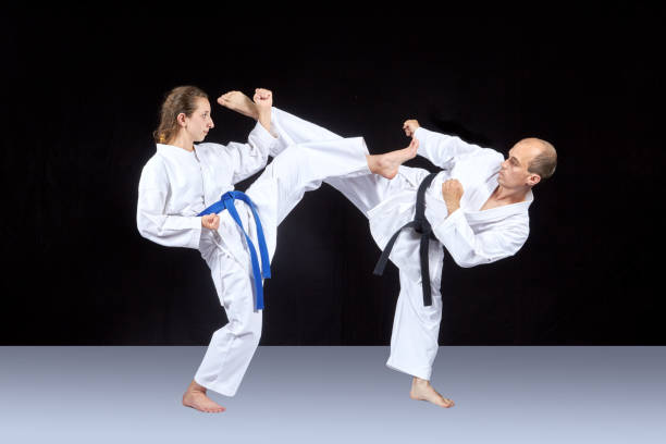 istock Athletes in karategi are training kicking in pairs 701050692