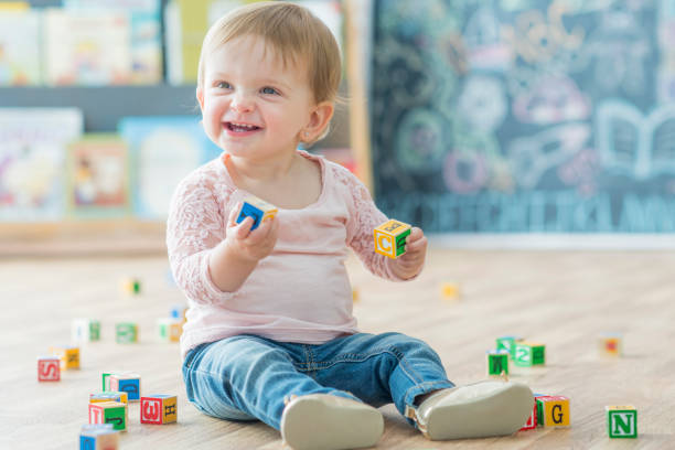 istock Baby Girl Plays with Blocks 701055012