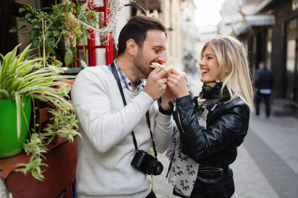 istock Young attractive couple sharing slice of pizza 701057836