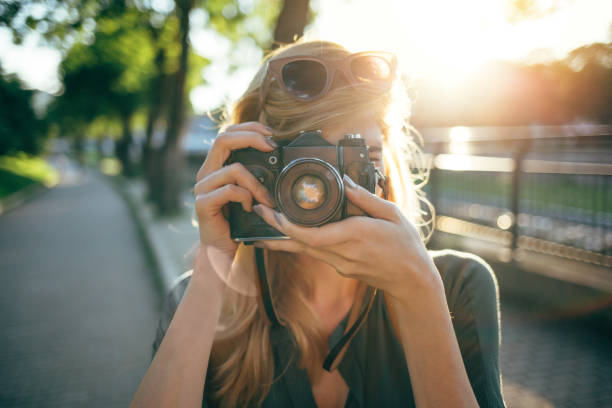 istock Tourist woman making memories with camera 701062652