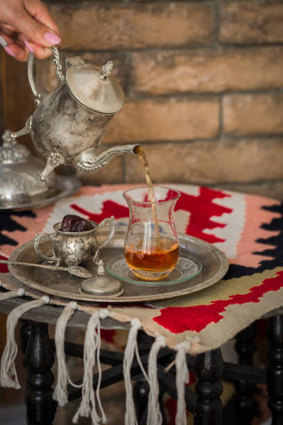istock Tea set in oriental style in pear shaped glass with vintage kettle and dates fruit 701066054