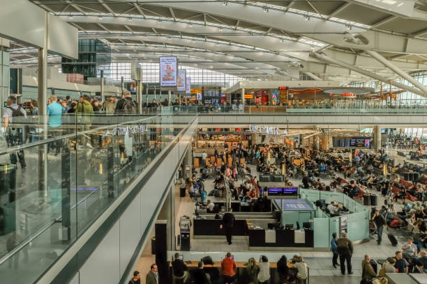 Heathrow, London - March 7, 2017: Heathrow Airport, Terminal 5, Heathrow Airport, Terminal 5, passengers waiting to get gate information, mid-morning. heathrow airport stock pictures, royalty-free photos & images