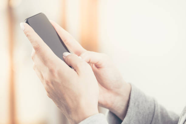 istock Hipster woman holding a smartphone in her hands. 701072060