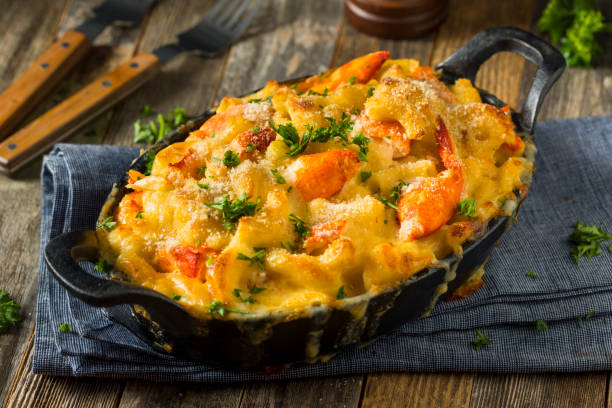 Homemade Lobster Macaroni and Cheese Homemade Lobster Macaroni and Cheese with Parsley and Pepper seafood gratin stock pictures, royalty-free photos & images