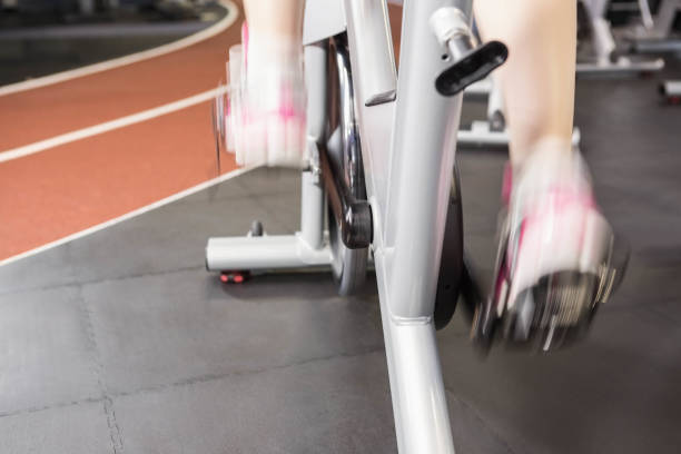 istock Pregnant woman using exercise bike 701077280