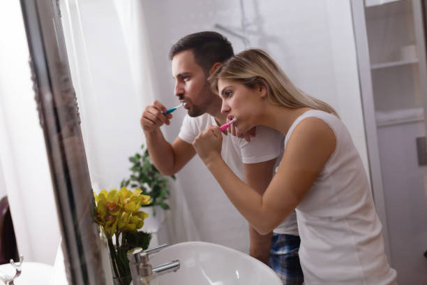 istock Attractive couple washing teeth in morning together 701077390