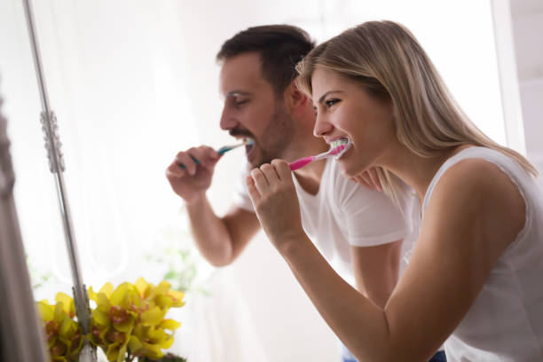 istock Attractive couple washing teeth in morning together 701077484