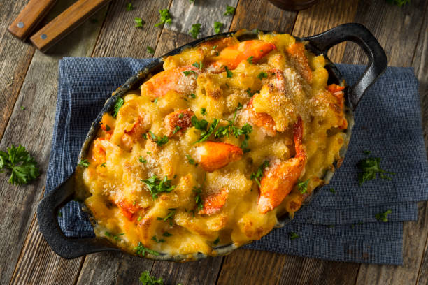 Homemade Lobster Macaroni and Cheese Homemade Lobster Macaroni and Cheese with Parsley and Pepper seafood gratin stock pictures, royalty-free photos & images