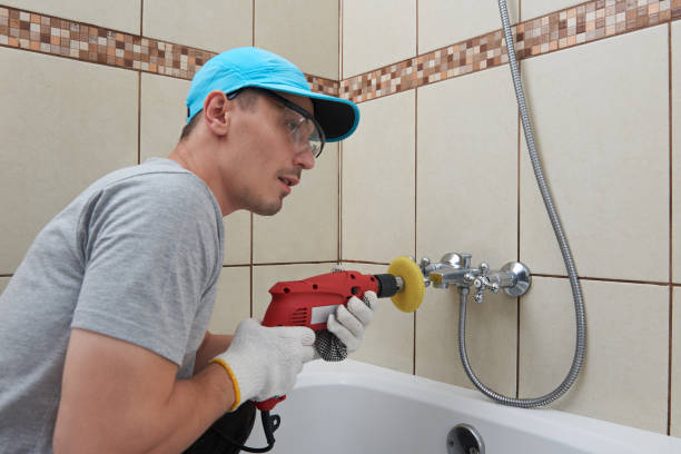 istock Man cleaning bath tub faucet 701085106