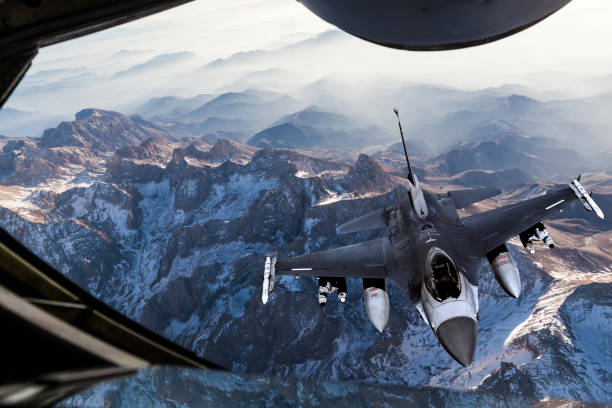 Mid-air Refueling over the mountains Mid-air Refueling of a fighter jet over the mountains military tanker airplane photos stock pictures, royalty-free photos & images