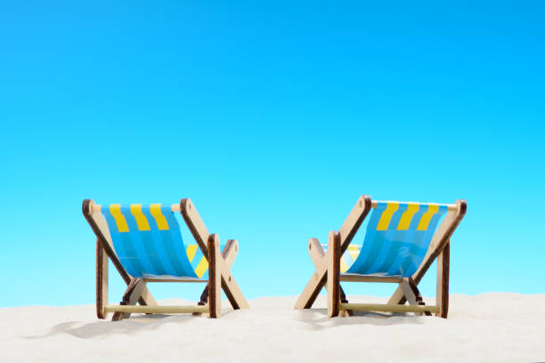 istock Two sunbeds at the beach on background of blue sky 701100620